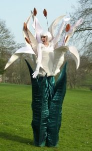 Flower Stilt Walker for hire. Book our summer-themed walkabout for family fun days in the UK & London.