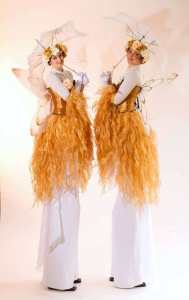 The Golden Harvest Fairies for hire. Our fairy stilt walkers are available to book for shopping centre events, picnic events or eco-themed events in London & the UK.