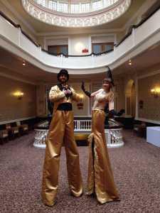 Stilt walkers for hire. Book our Golden Stilt Walkers for shopping centre events in London & the UK.