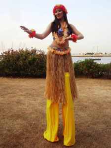 Hawaiian Stilt Walkers for hire. Our Hula Dancer Stilt Walker is available to book for beach-themed events in London & the UK.