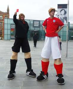 book our professional stilt walkers for your sports themed event. Available in London and the UK.