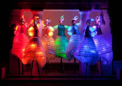 Vibrant Stilt Walkers for hire. Our LED stilt walkers are available to book for family fun days, summer festivals or carnivals in London & the UK.