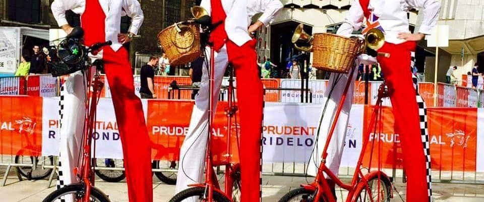 Checkered Cyclist Stilt Walkers for hire. Our comedy cycling stilt walkers are available to book for family fun days, Easter events or shopping centre events in London & the UK. Checkered Cyclist Stilt Walkers for hire. Our comedy cycling stilt walkers are available to book for family fun days, Easter events or shopping centre events in London & the UK.