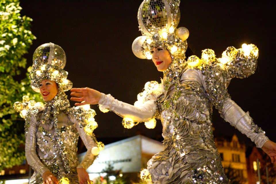Christmas-themed stilt walkers for hire. Our Glitter Ball Stilt Walker is available to book for corporate events in the UK & London.