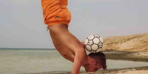 Freestyler-Balances-Ball-On-Head-With-Performing-Hand-Stand