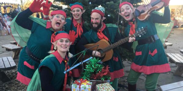 Group-Of-Christmas-Elves-At-Market