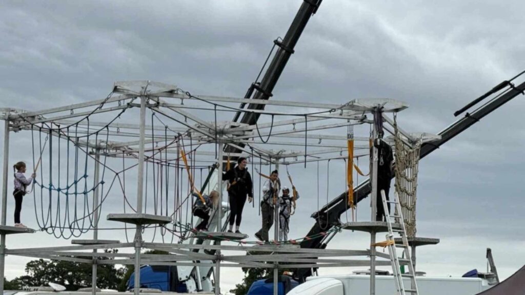 A mobile high ropes course at a family fun day event.