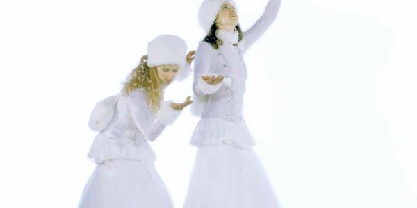 Stilt-Performers-Playing-In-Snow
