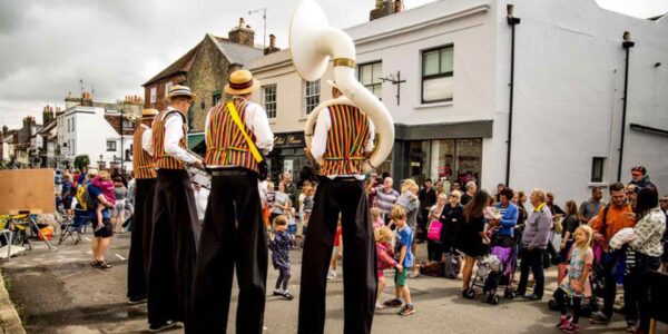 Victorian-Themed-Band-With-Stilts-And-Crowd