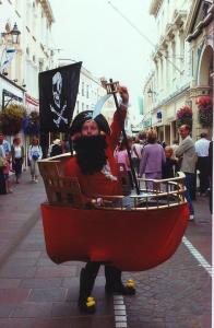 Pirate in a ship walkabout act for hire. Book our comedy walkabout act for outdoor festivals in the UK & London.
