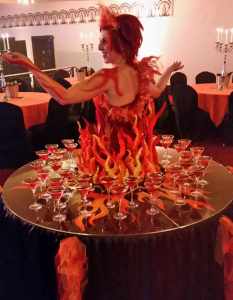 Halloween-themed human table for hire. Book our Fire Fairy Human Drinks Table for corporate events in London & the UK.