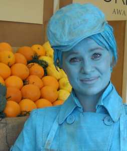 Shop keeper themed human statue in Turquoise.