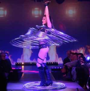 Circus-themed entertainment for hire. Book The Astonishing Hula Hooper for gala dinners in the UK & London.