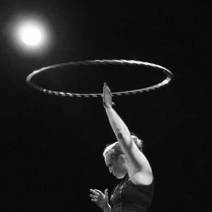 Cirque-style hula hoop performer available to hire for circus-themed events around the UK.