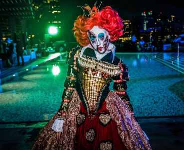 Walkabout horror-themed Red Queen act for hire for Alice in Wonderland-themed events.