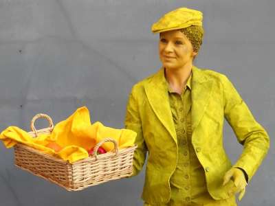 Yellow poet and fruit seller human statue for hire London and the UK