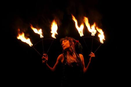 Fire performer for hire. Book our fire fan dancer for festivals in the UK & around the world.