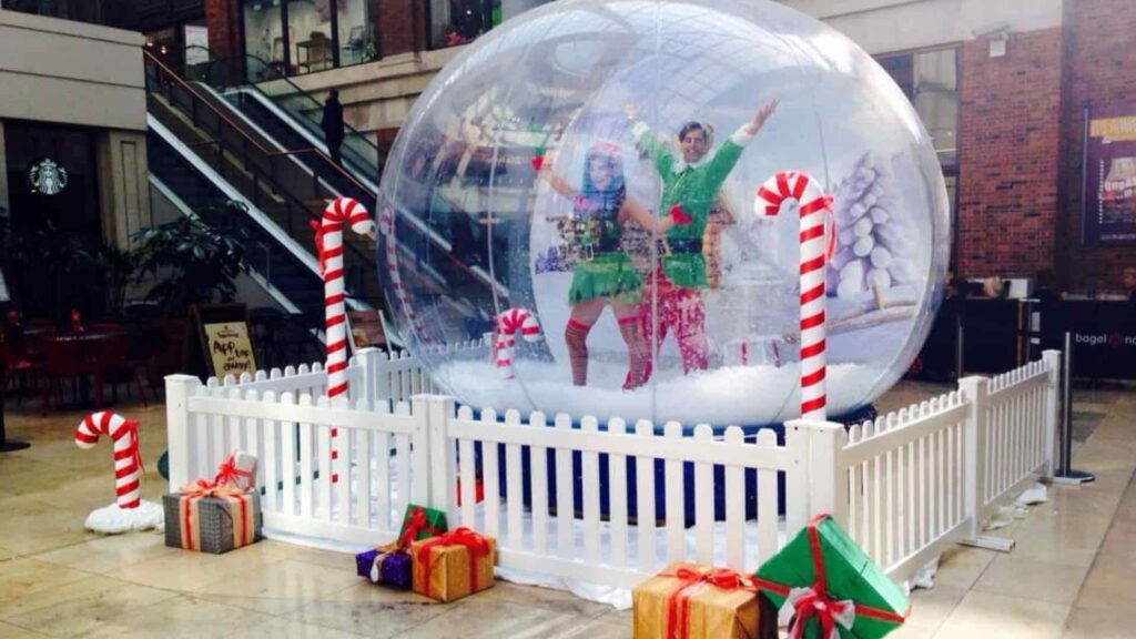 Elf performers in snow globe photo booth experience