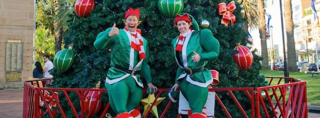 Christmas-Elves-Wearing-Jumping-Stilts Christmas-Elves-Wearing-Jumping-Stilts