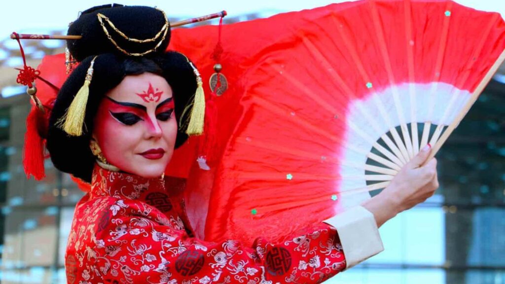Japanese themed performer wearing traditional kimono and holding a fan