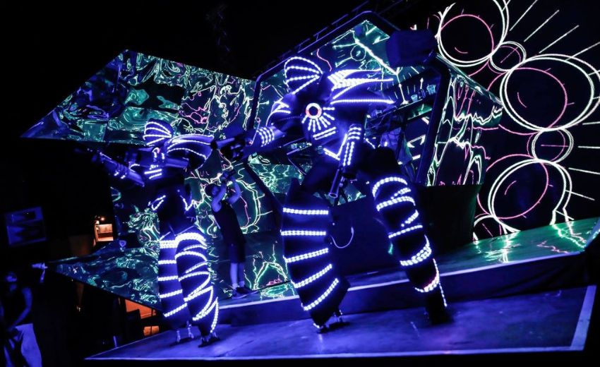 Globot dancers dancing on stage at festival themed event.
