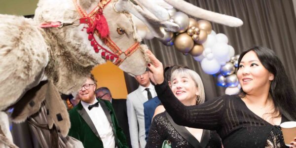 Guests-Stroking-Reindeer-Stilt-Walker