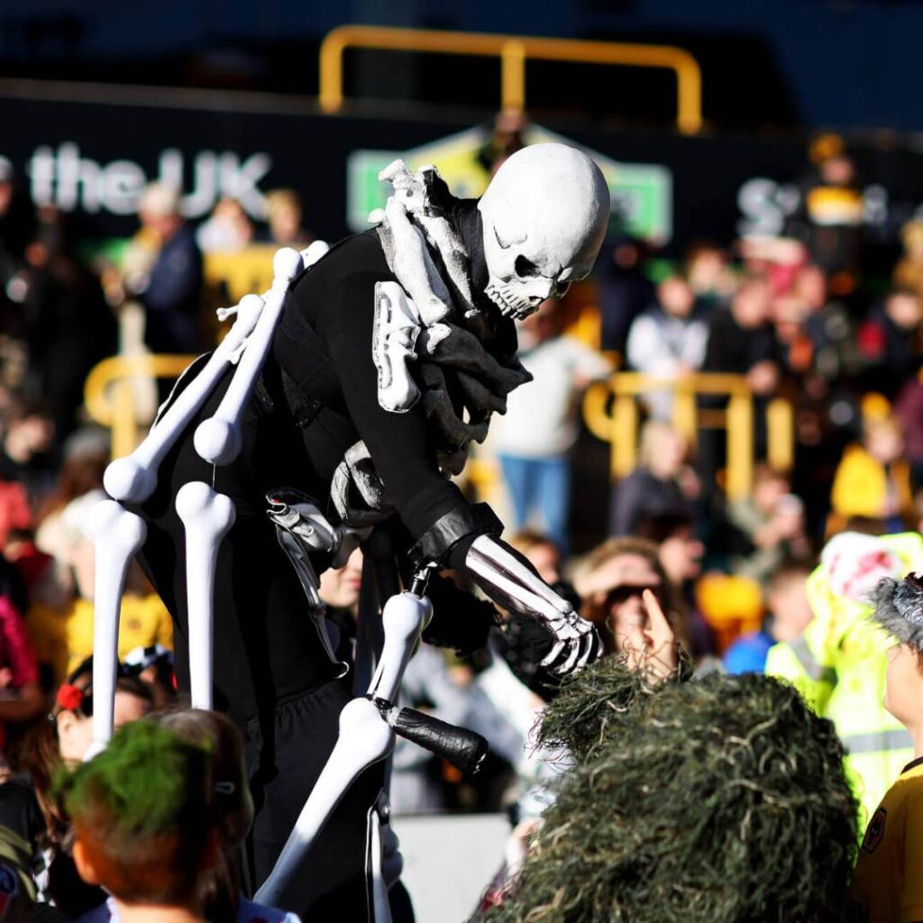 Skeleton walkabout performer interacting with audience.
