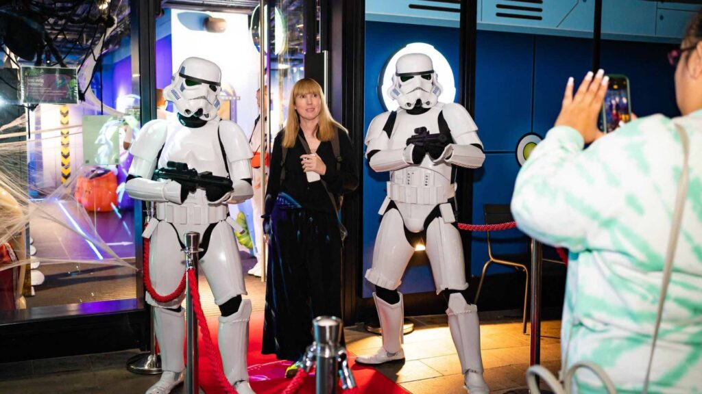 Woman poses for photo with storm troopers by the entrance to Babylon Park Camden