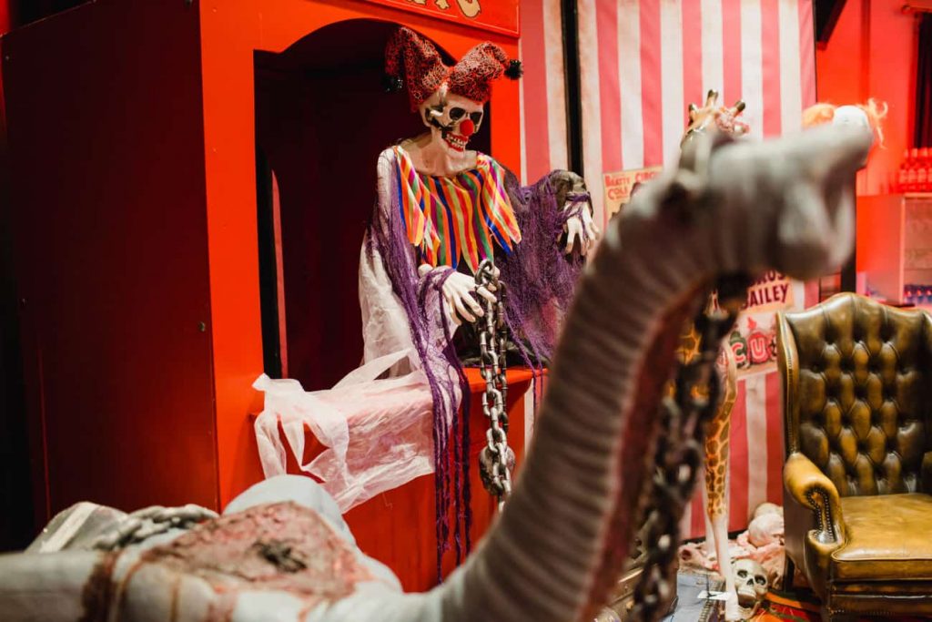 Bespoke Twisted Circus Themed Photo Booth with a Circus Ticket Booth and Circus Elephant prop we designed for the Halloween Birthday Party guests to take unique photos home with them after the event.