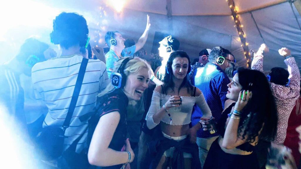 People wearing headphones and dancing to music playing through them