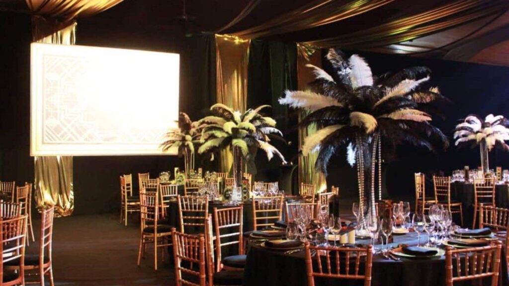 Large palm tree table decorations at gala dinner event.