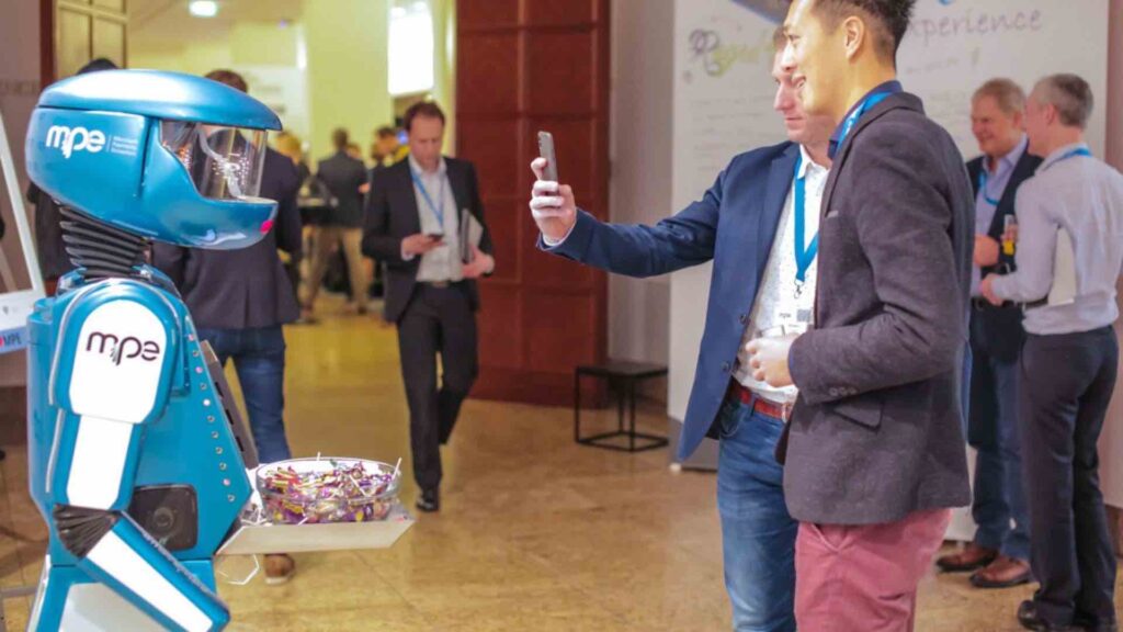 Robot poses for photo at corporate event