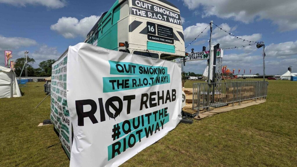 'Quit smoking the R.I.O.T way! Riot Rehab #QuitTheRiotWay' on banner.