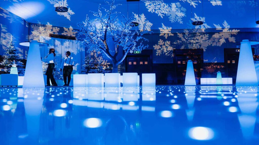 White cubes, snowflake projections, sparkling crystal trees and blue uplighting used as part of winter wonderland theming for this Christmas event
