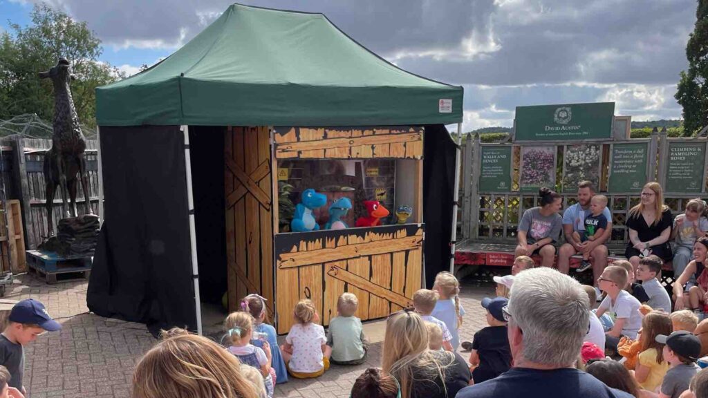 Families gathered to watch dinosaur puppet show at Frosts Garden Centre Jurassic Walkabout Weekend.
