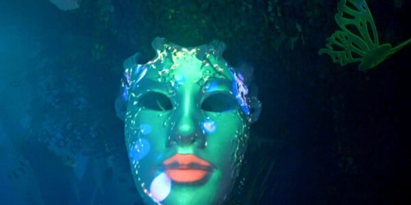 Neon giant mask, part of a futuristic rainforest themed event.