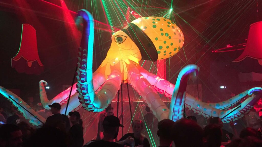 Giant pink, blue and orange octopus puppet with LED lights at a sea themed event.