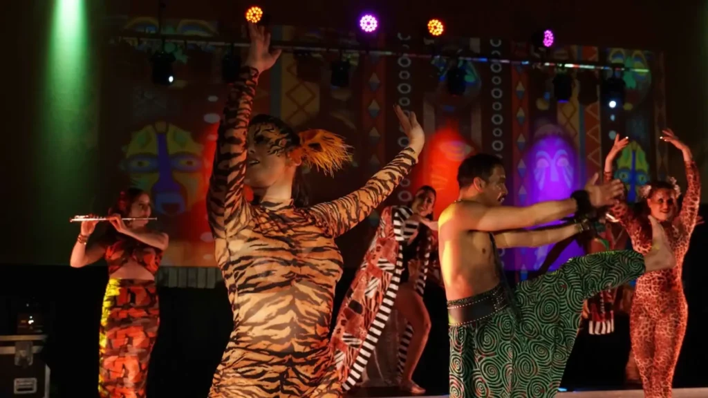 Jungle themed event performers dancing on stage.