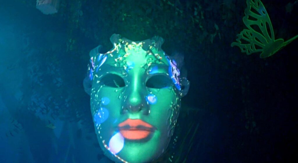 Neon giant mask, part of a futuristic rainforest themed event.