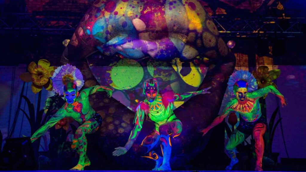 Jungle themed safari entertainers in bright UV paint at corporate event.