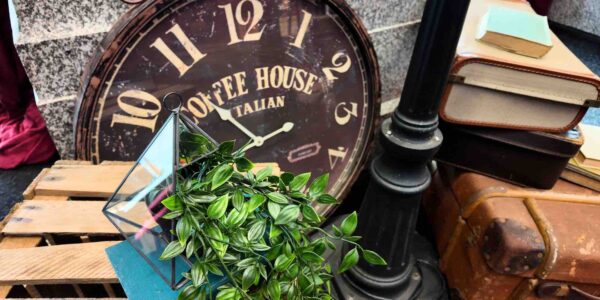 Vintage clock with lamppost and fake foliage used for a 1940s themed event.