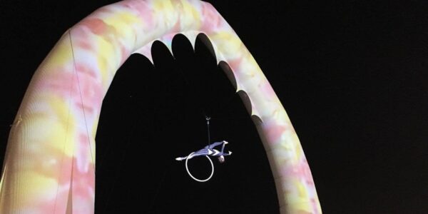 Aerialist-Hoop-Performer-Hanging-From-Colourful-Archway
