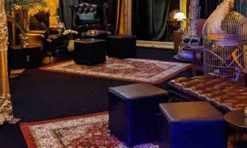 Various 1920s themed props including rugs, palm trees ostrich feathers and more used to decorate Gatsby themed room.