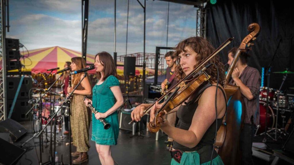 Band on stage performing to guests at company summer festival