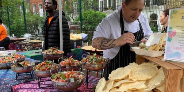 Catering-Staff-Serving-Guests-At-Festival-Themed-Event