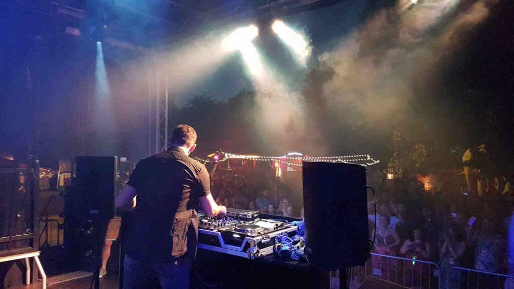 Live DJ performing for guests attending corporate festival