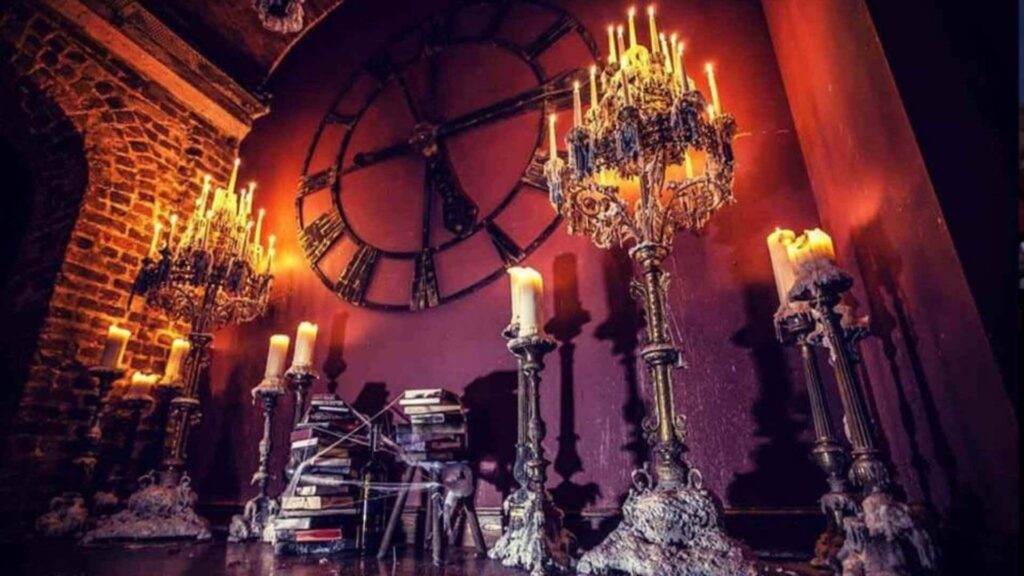 Venue decorated with candelabras and cobwebs to create gothic Halloween theming