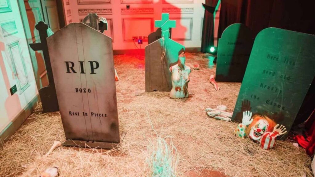 Twisted circus themed graveyard with headstone props