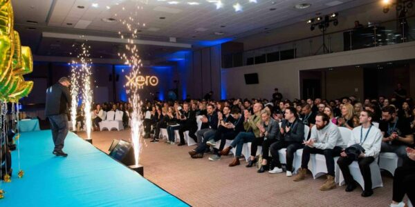 Guest speaker on the Xero stage presenting an award at Milton Keynes conference designed by conference event planners Julia Charles Event Management.