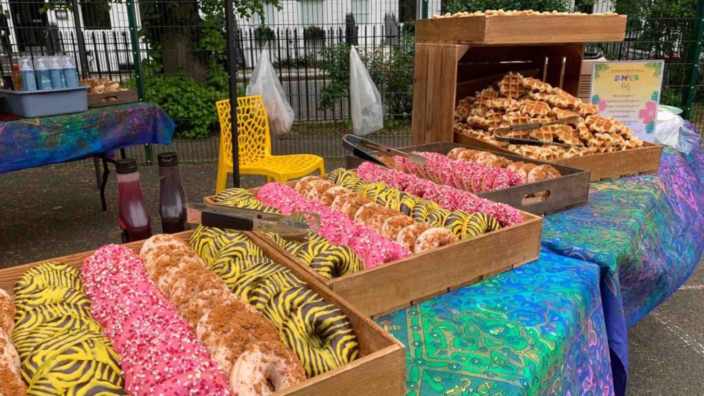 Trays of doughnuts laid out on catering tables